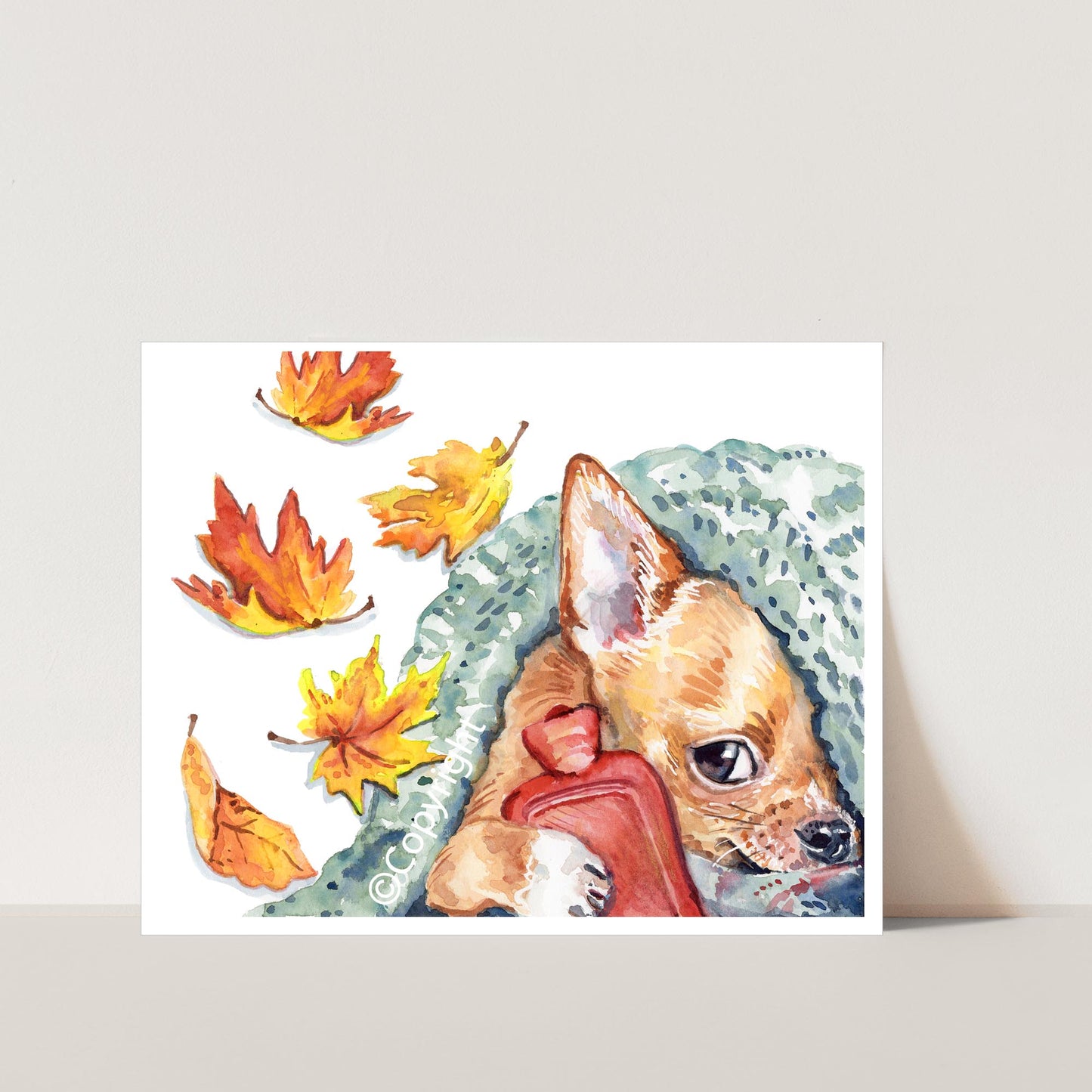 Illustration of a small dog hiding under a blanket with a hot water bottle and autumn leaves