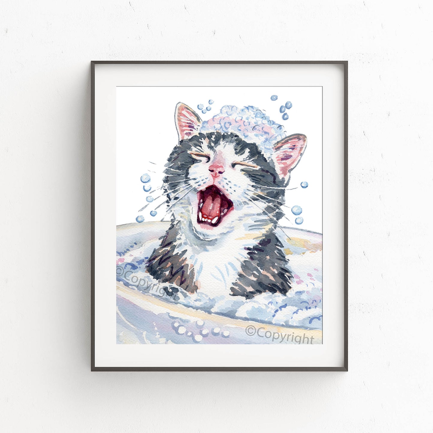 Framed artwork of a cat in water with bubbles on a white wall.