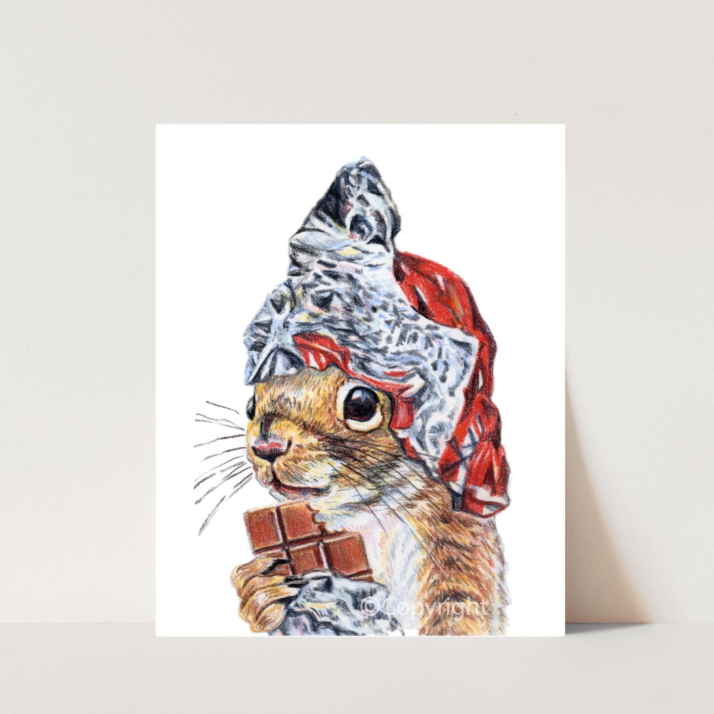 Drawing of a squirrel wearing a hat made out of tine foil while holding a chocolate bar on a white background