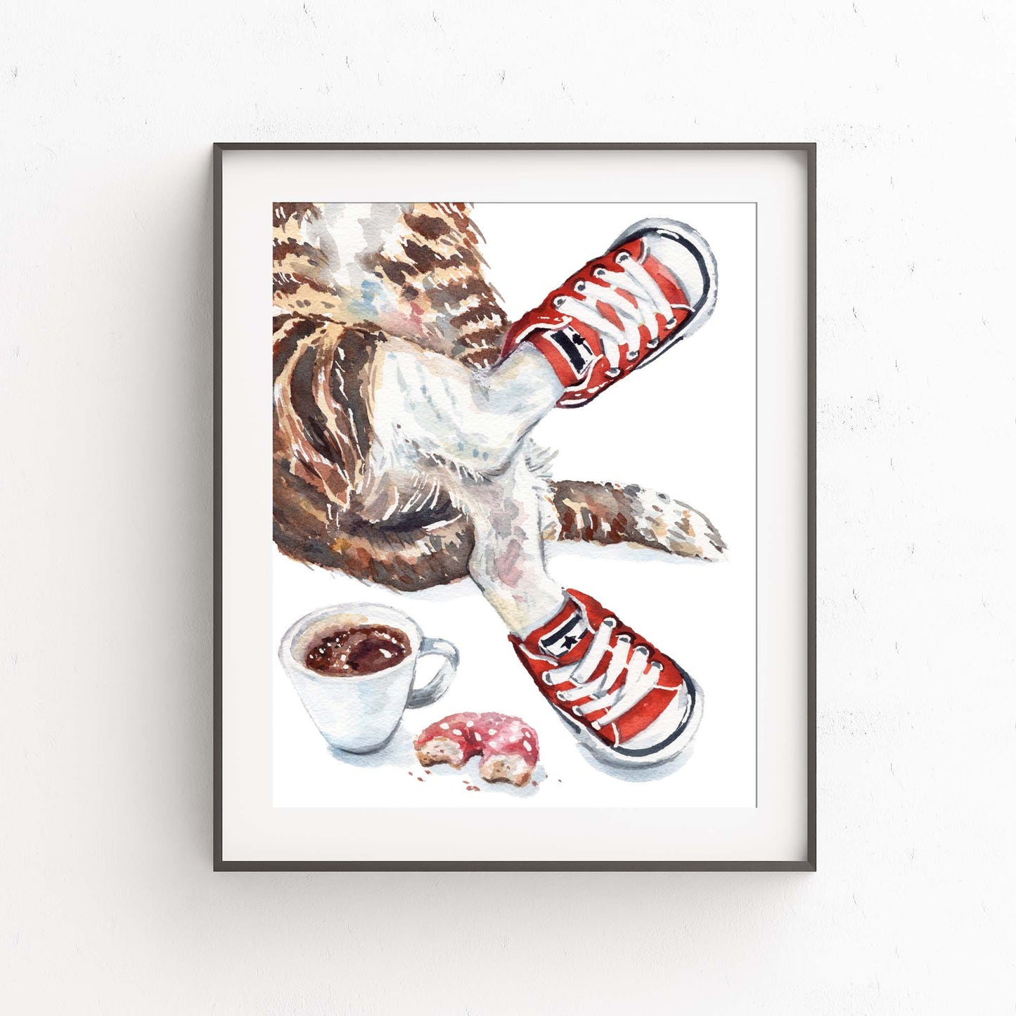 Framed artwork of a brown tabby cat wearing red sneakers with a cup of coffee and donut on a white background
