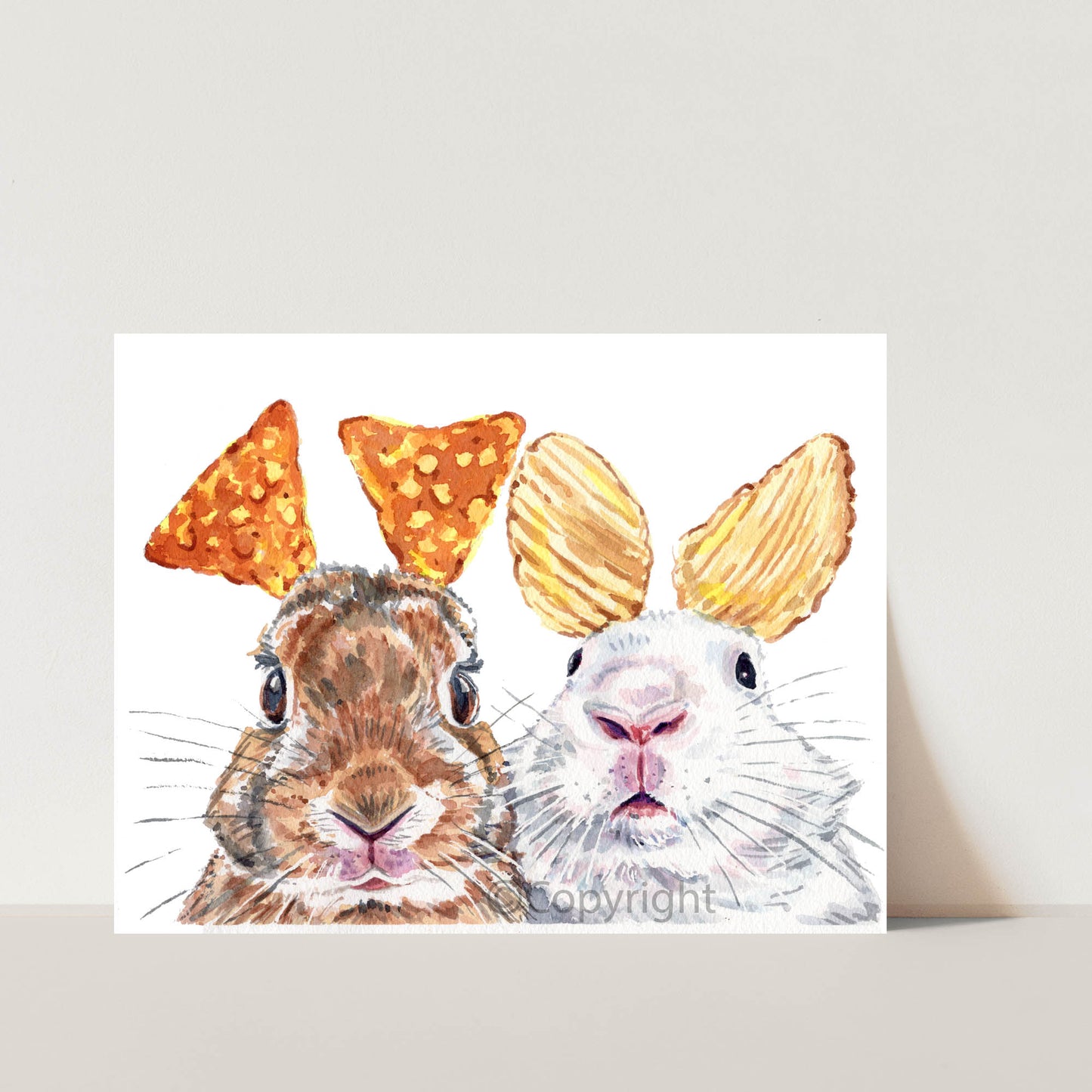 Two rabbits with ruffle chips and cheese nachos for ears on a white background. Watercolour painting by Deidre Wicks