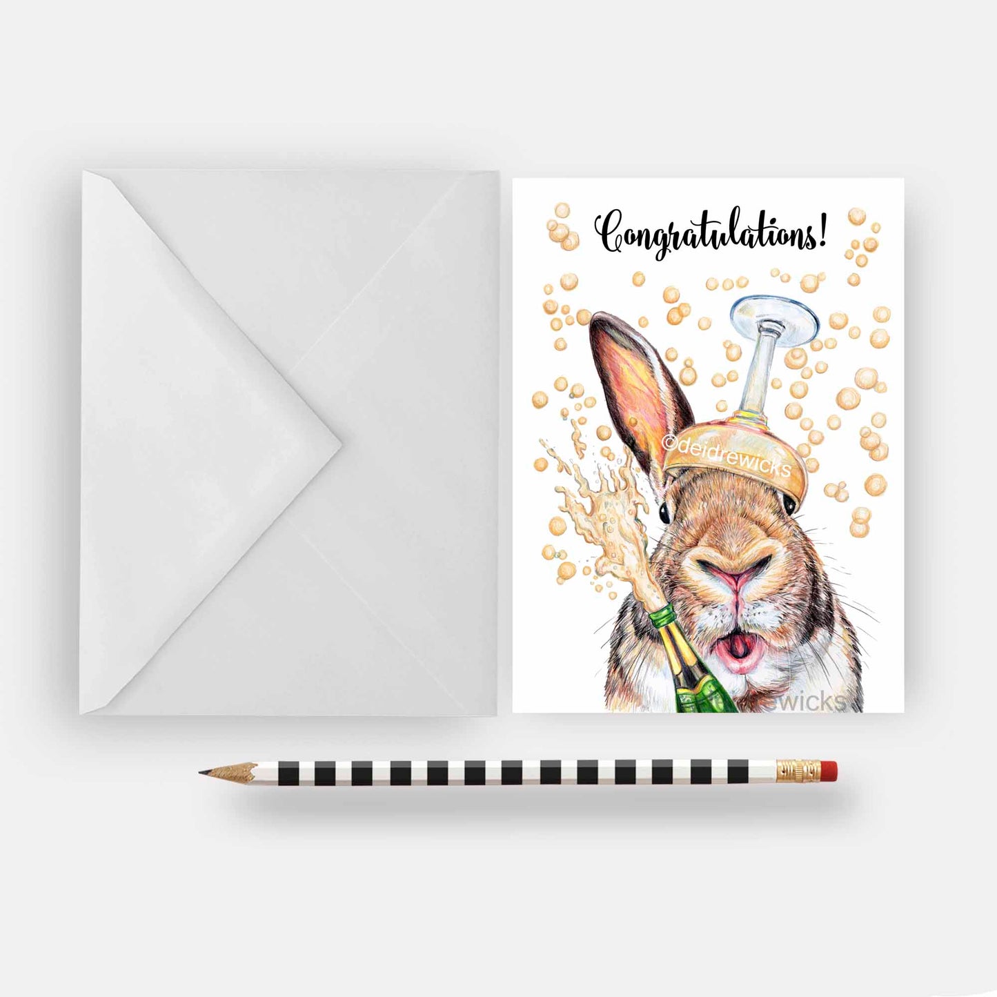 Congratulations greeting card featuring a bunny rabbit with a sparkling bottle of wine and a glass. By Deidre Wicks