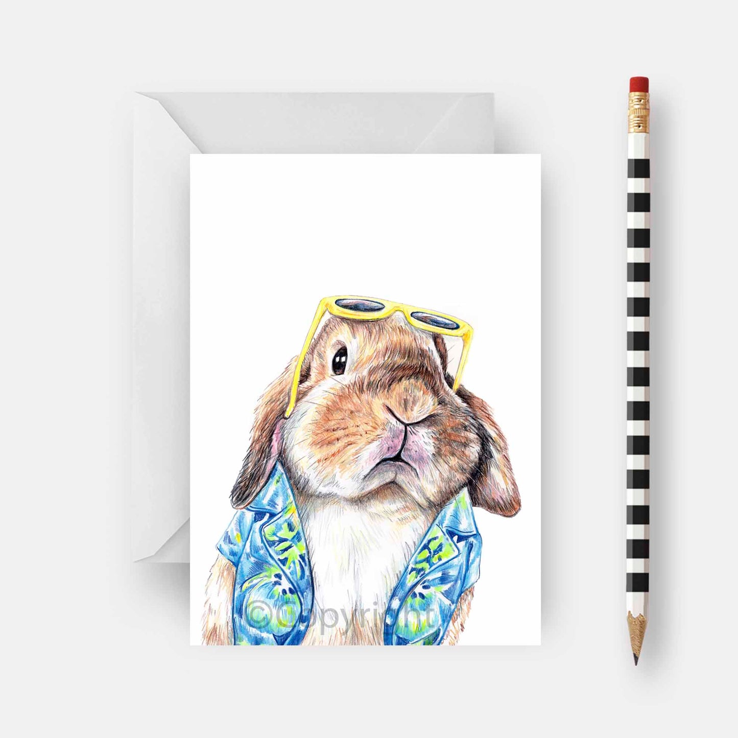 Blank greeting card featuring a lop eared bunny rabbit wearing a Hawaiian shirt. Art by Deidre Wicks