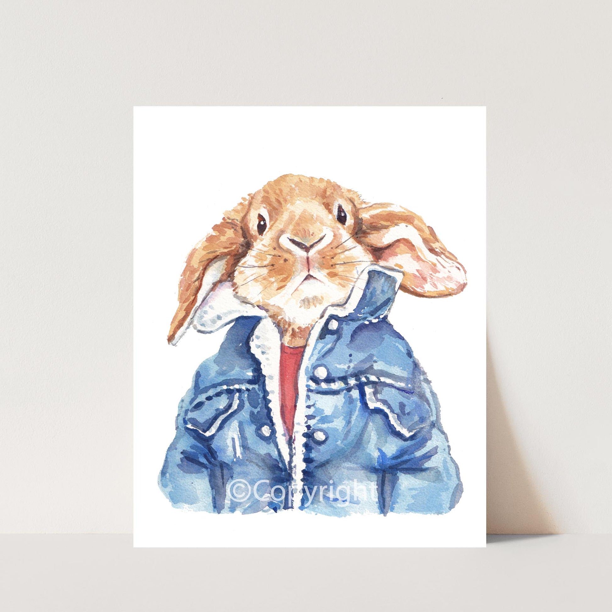 Watercolour painting of a lop eared bunny rabbit wearing a cool vintage denim jacket. Art by Deidre Wicks