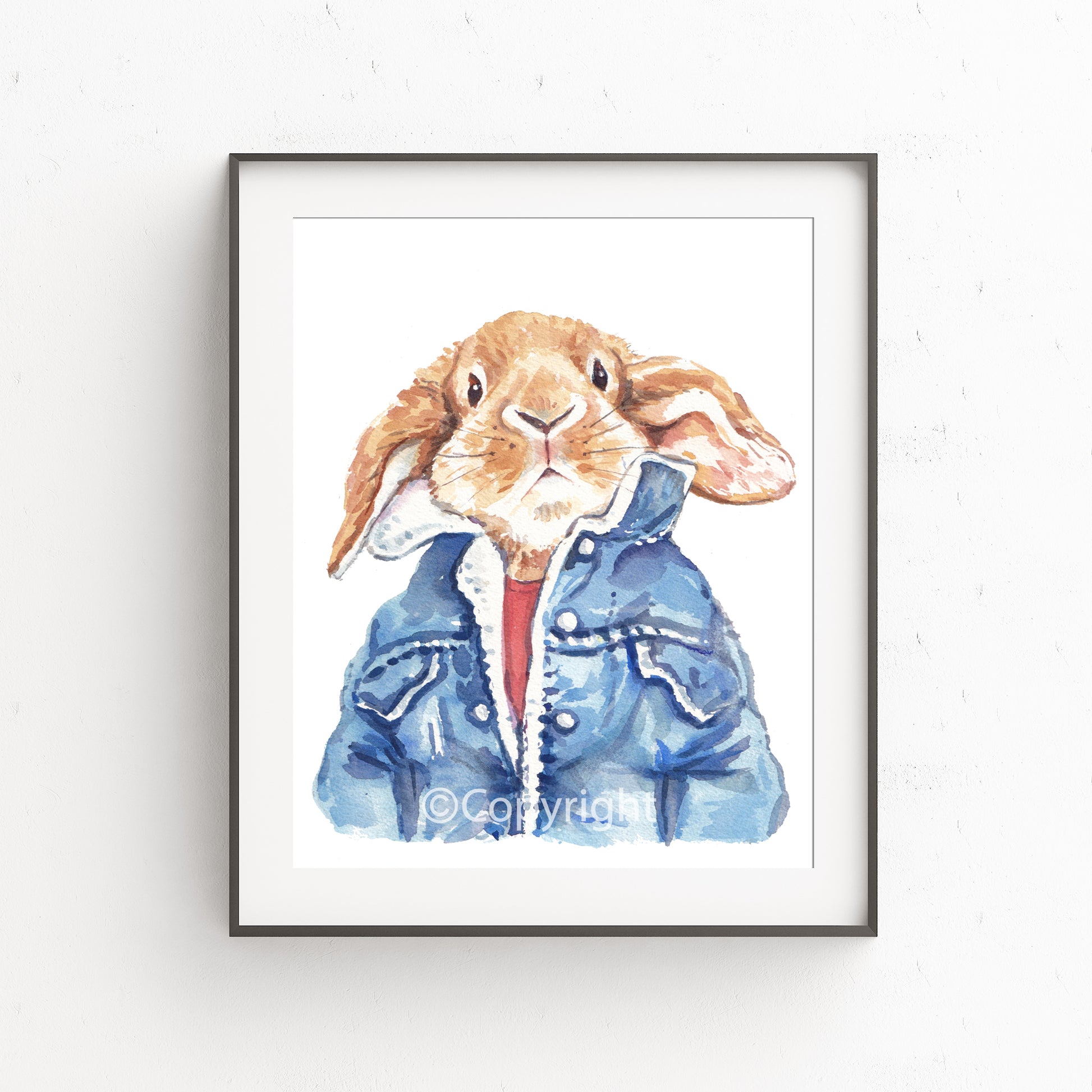 Watercolour painting of a lop eared bunny rabbit wearing a cool vintage denim jacket. Art by Deidre Wicks