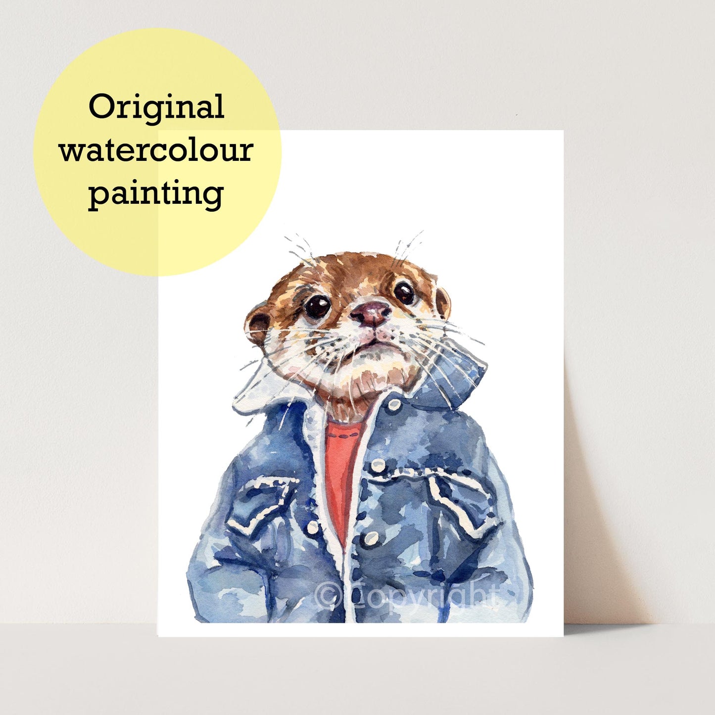 An original watercolor painting of an otter wearing a blue jacket and red shirt, displayed on a white card against a light beige background with a yellow circle label reading 'Original watercolour painting'.