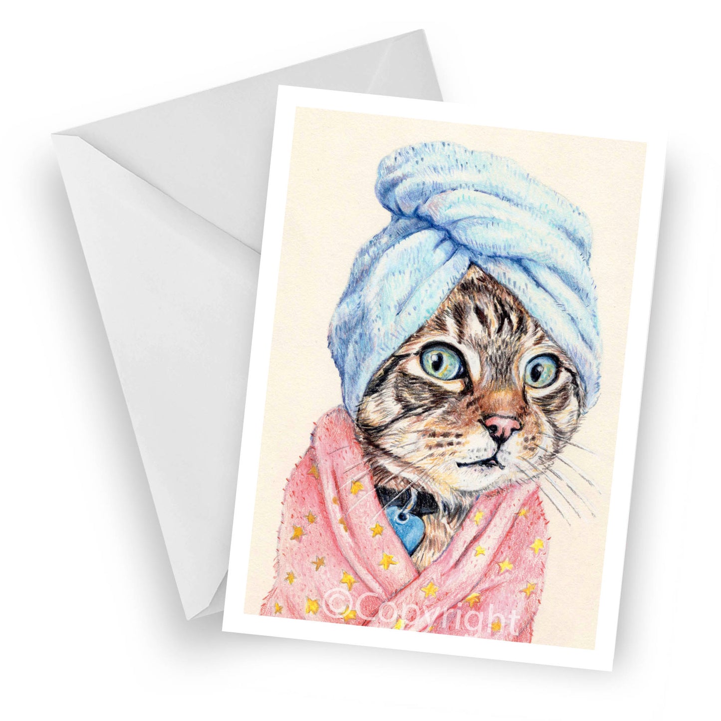 Greeting card featuring a coloured pencil drawing of a brown tabby cat wearing a bath towel and fuzzy pink bath robe. Art by Deidre Wicks