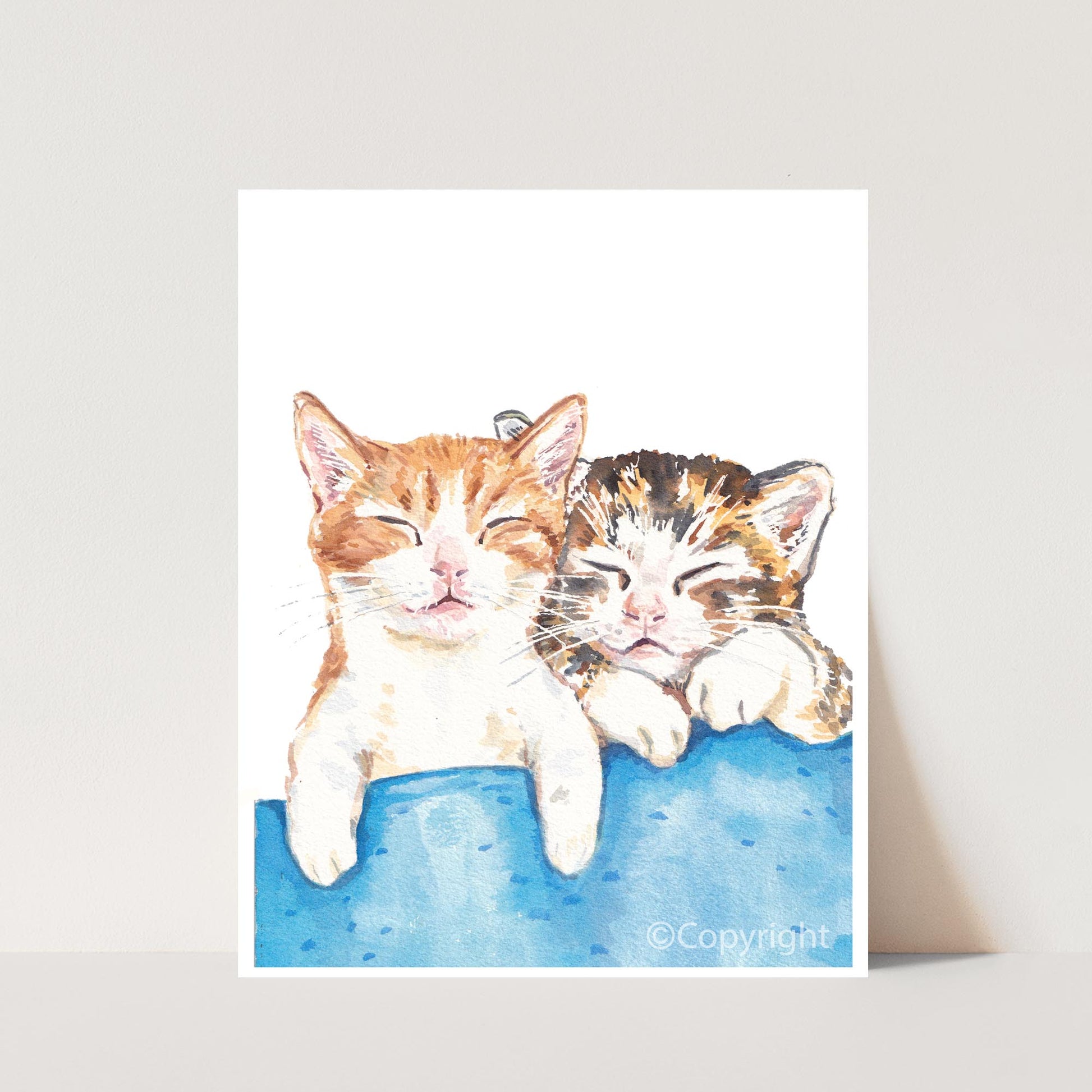 Watercolour painting of two tabby kittens taking a nap together. Art by Deidre Wicks