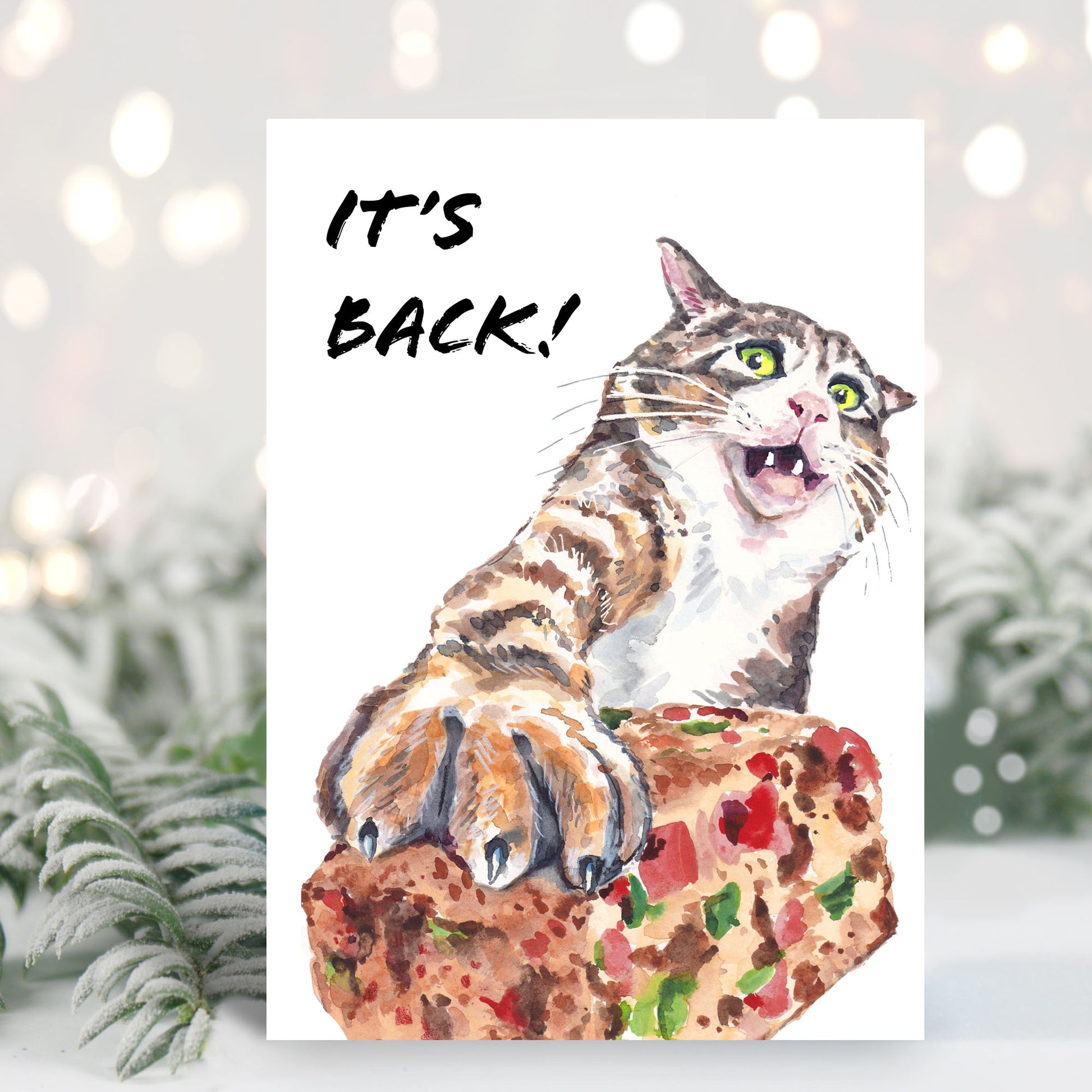 Christmas card featuring a watercolour painting of a horrified tabby cat pushing away a chunk of fruitcake