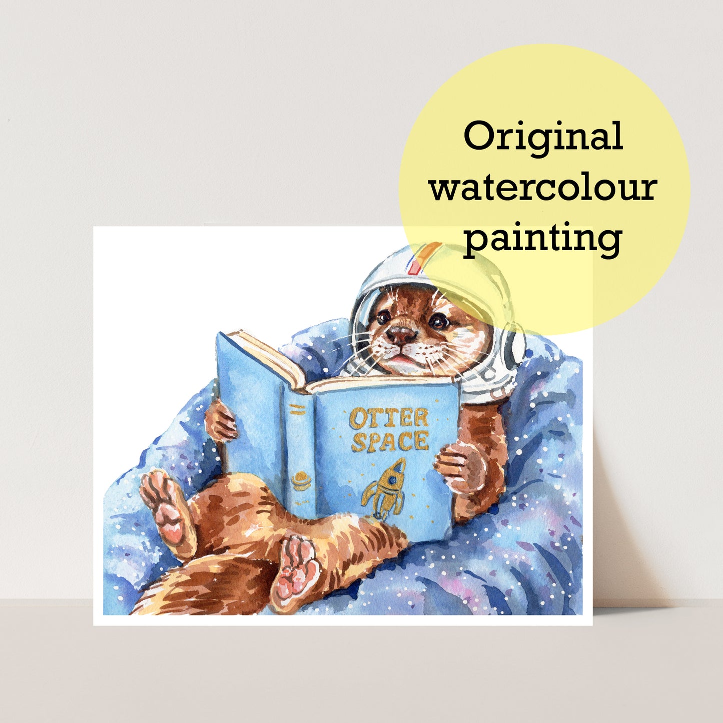 Watercolor painting of an otter in an astronaut suit reading a book titled 'Otter Space'.