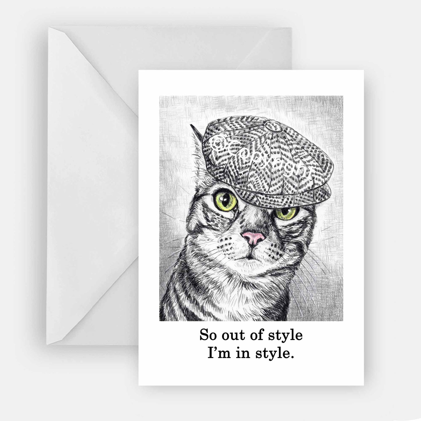 Blank greeting card featuring a black and white wax pastel drawing of tabby cat wearing a cap. Art by Deidre Wicks