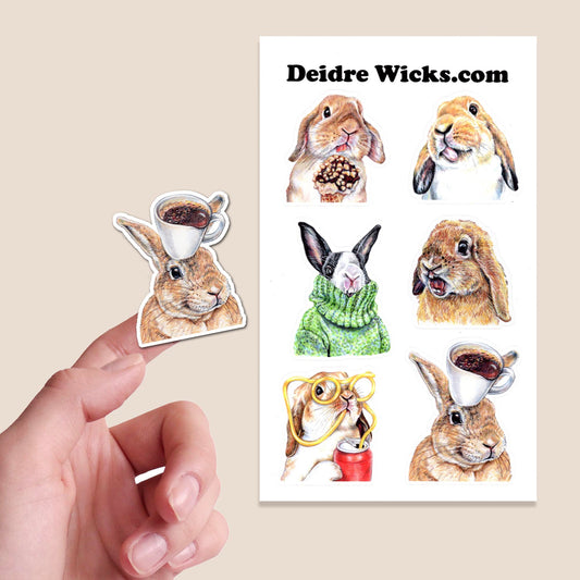 Sticker sheet with hand drawn rabbit illustrations and a hand holding one of them, with 'Deidre Wicks.com' branding.