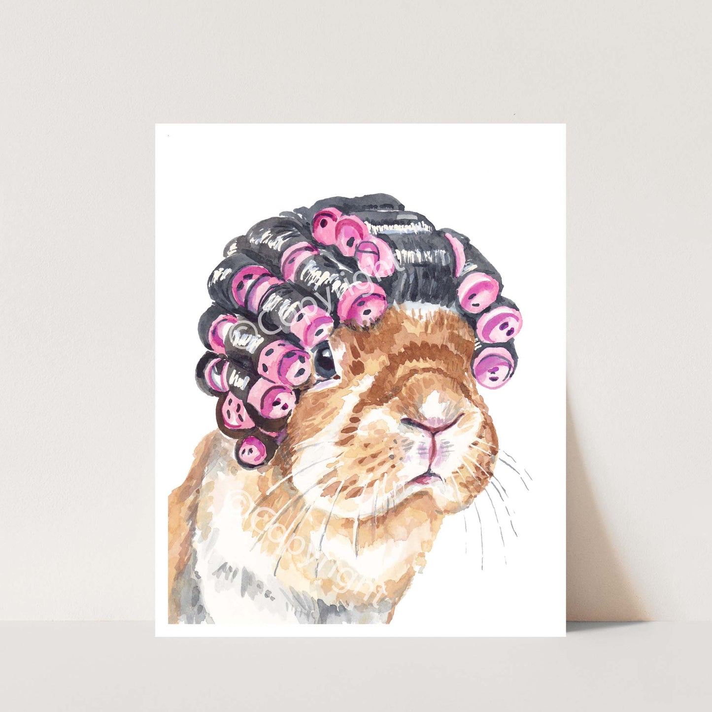 Watercolour painting featuring a lop eared bunny rabbit wearing bright pink hair curlers on her head by Deidre Wicks