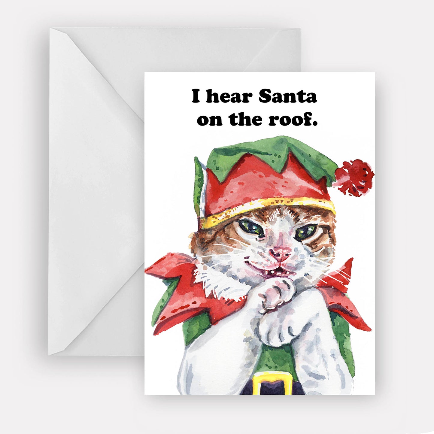 Cat in elf costume with text 'I hear Santa on the roof' on a white card with envelope.