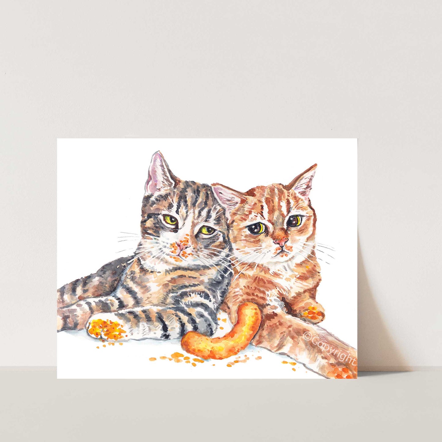 Watercolour painting of two tabby cats in a stand off over the last Cheeto cheese puff. Art by Deidre Wicks