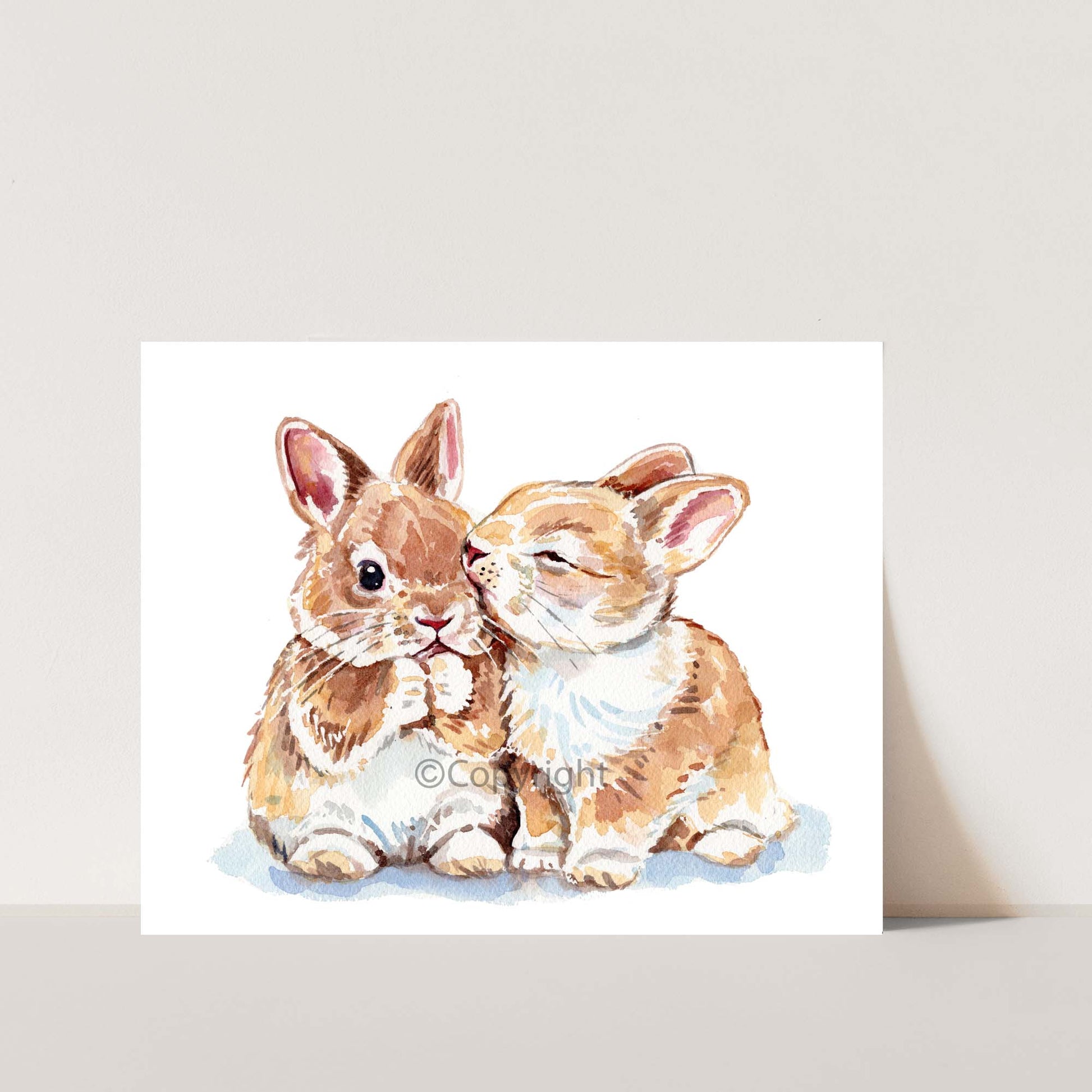 A painting of two tiny bunny rabbits, one that's kissing the cheek of the other
