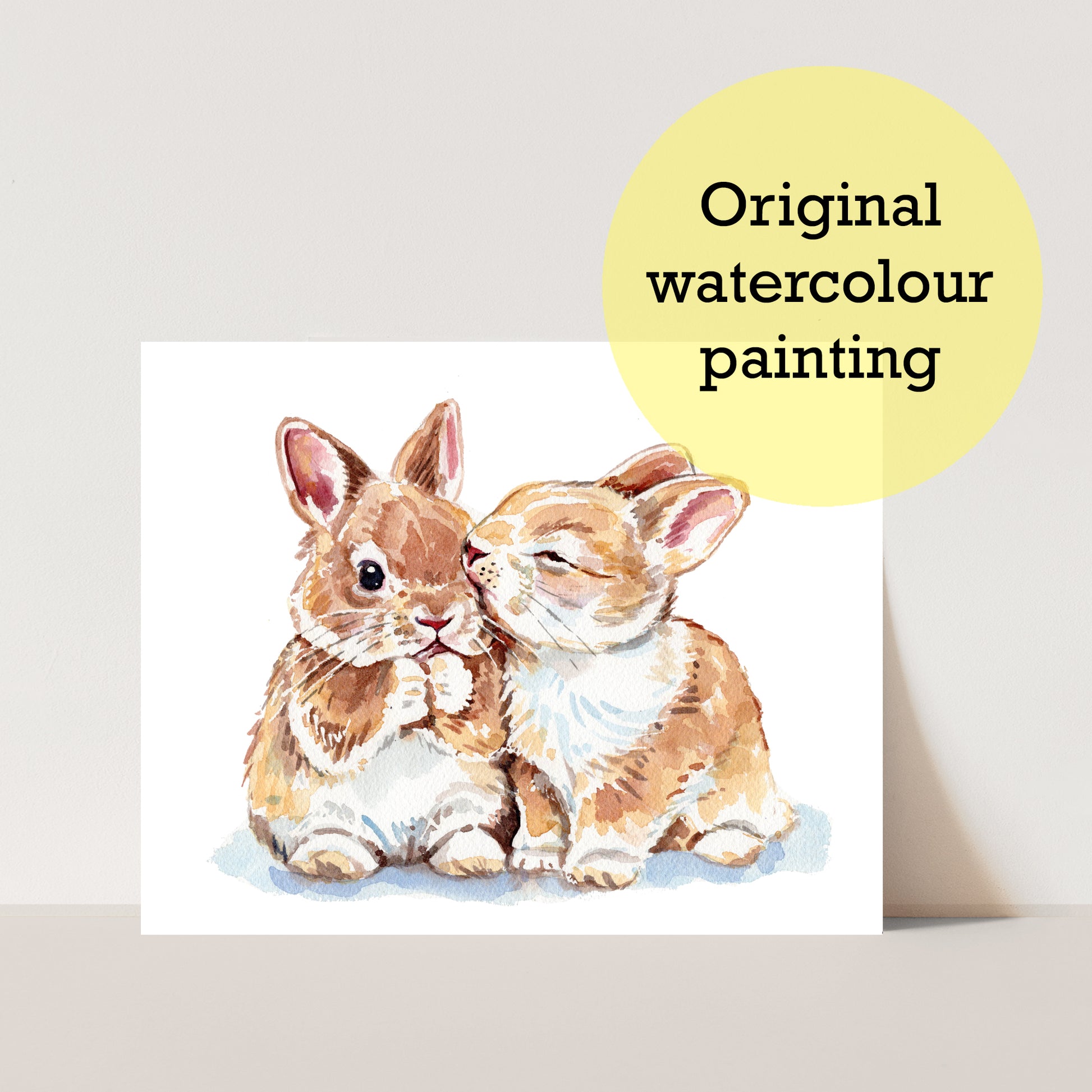 Original watercolor painting of two bunnies with a yellow label indicating 'Original watercolour painting'.