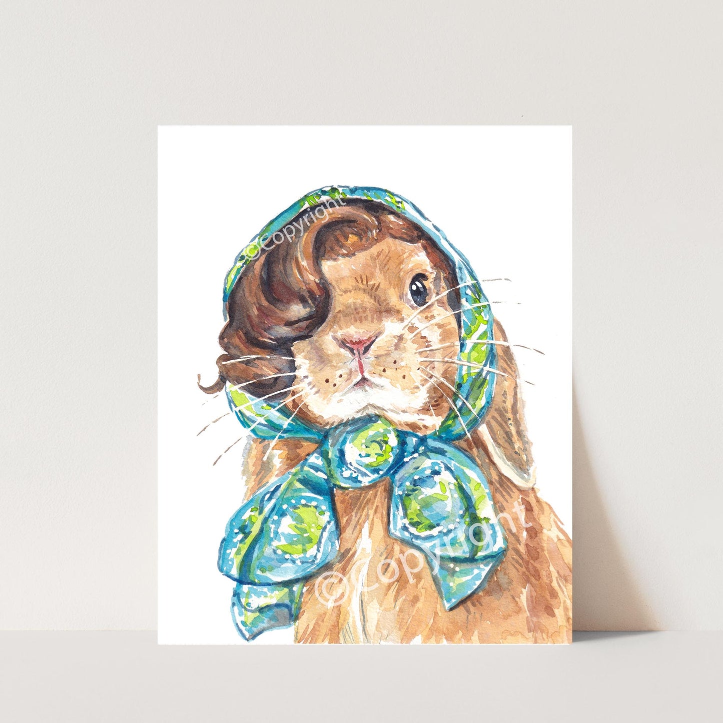 Watercolour painting of a lop eared bunny rabbit wearing a vintage head scarf. She's ready for a vacation. 
