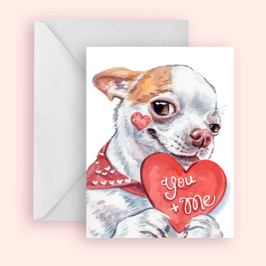 Greeting card with a dog holding a heart shaped 'You + Me' on a pink background