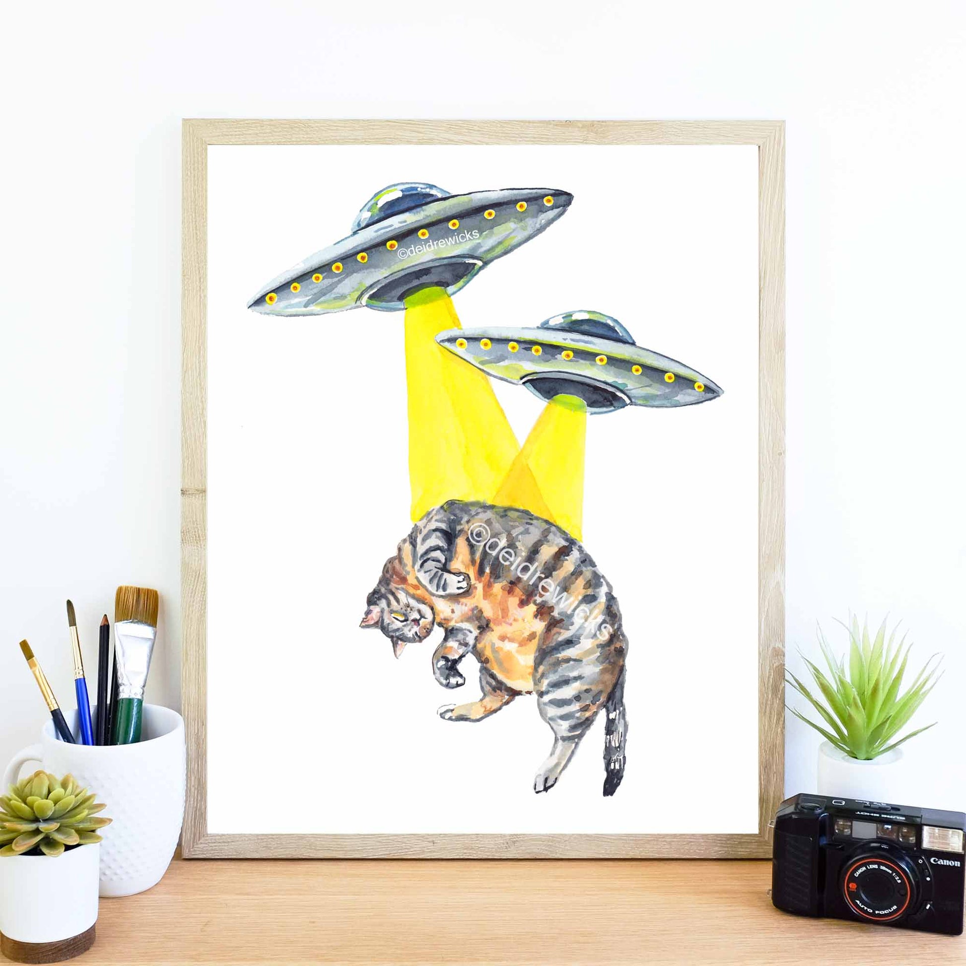 Framed brown tabby cat and ufo sci-fi watercolour print by Deidre Wicks