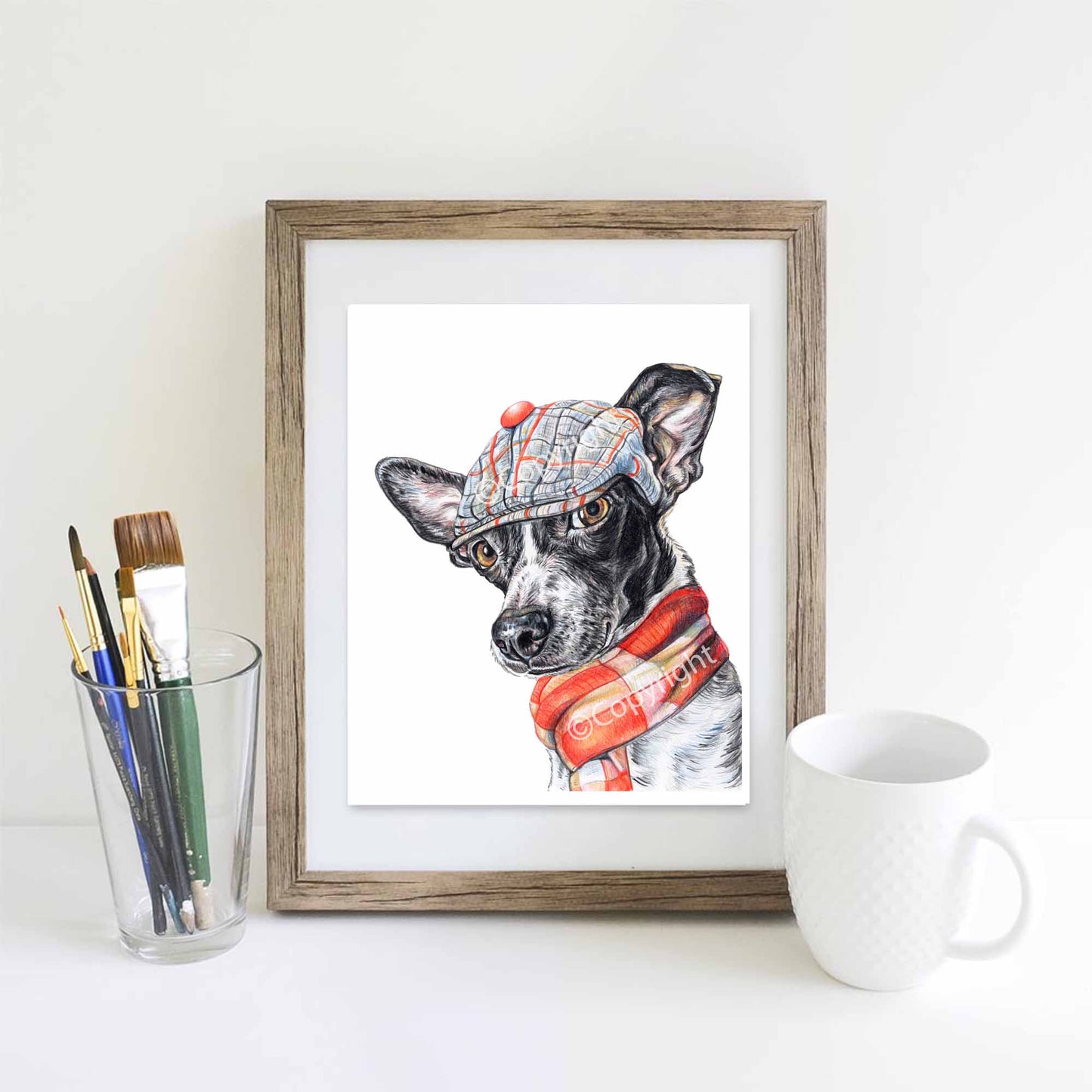 Coloured pencil drawing of a black and white terrier mix dog wearing a dapper cap and woold scarf. Art by Deidre Wicks