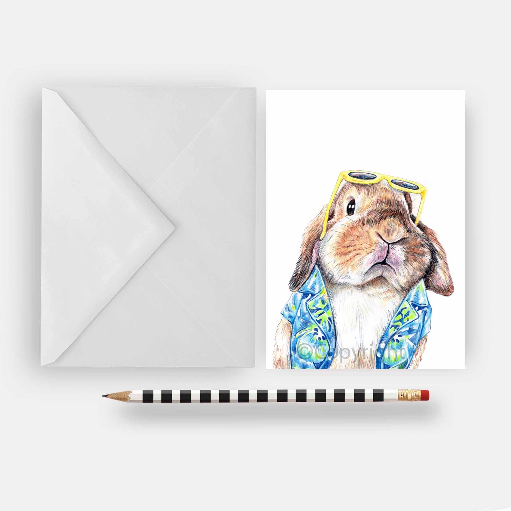 Blank greeting card featuring a lop eared bunny rabbit wearing a Hawaiian shirt. Art by Deidre Wicks
