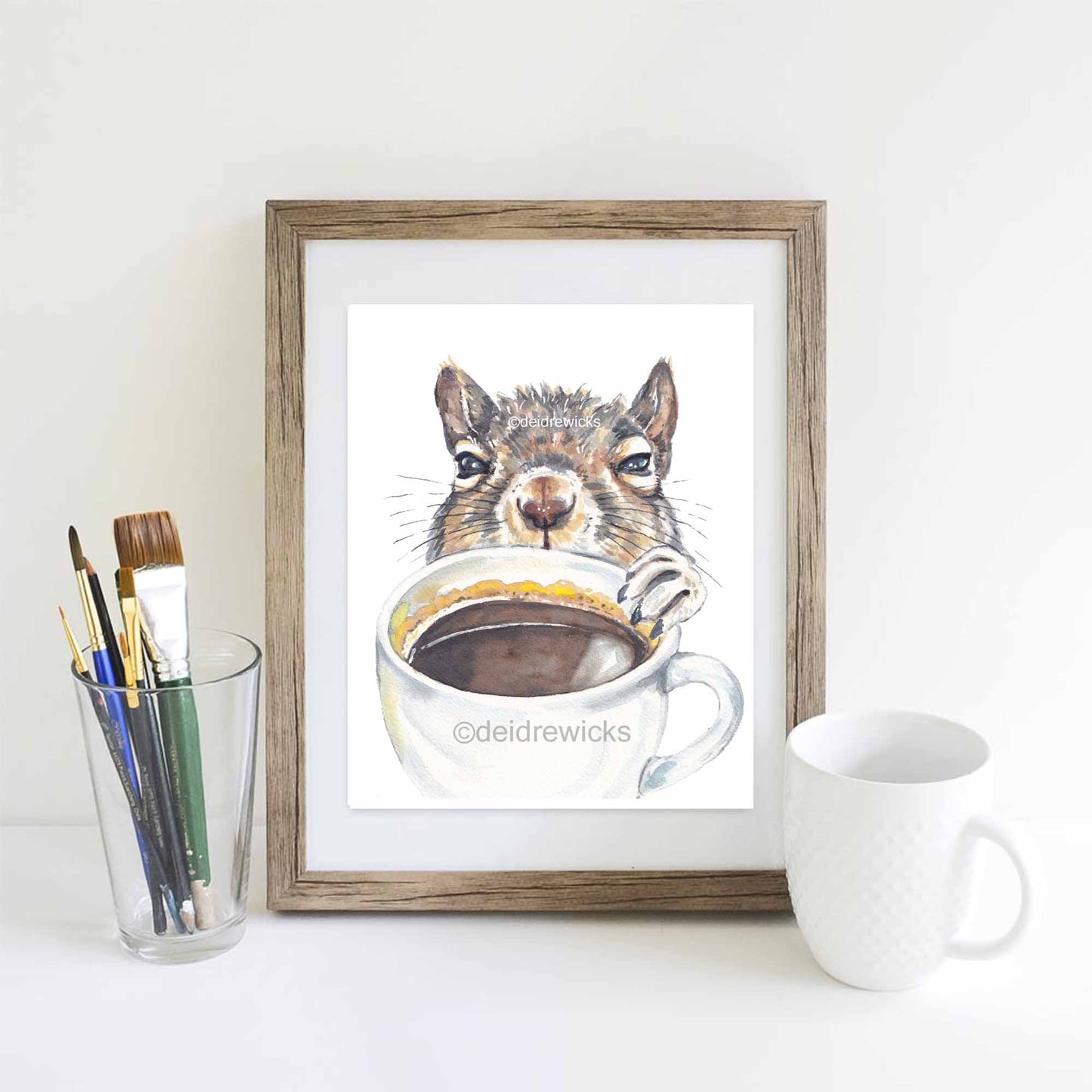 Watercolour painting of a bleary-eyed squirrel reaching for a cup of coffee. Original animal art by Deidre Wicks