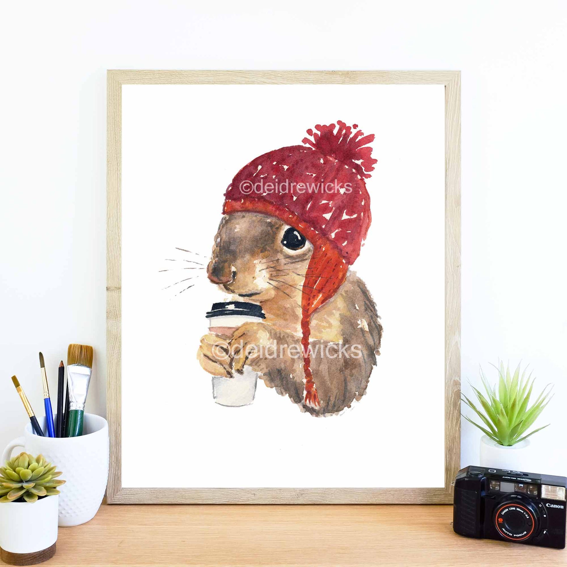 Framed example of a coffee drinking squirrel in a knit hat