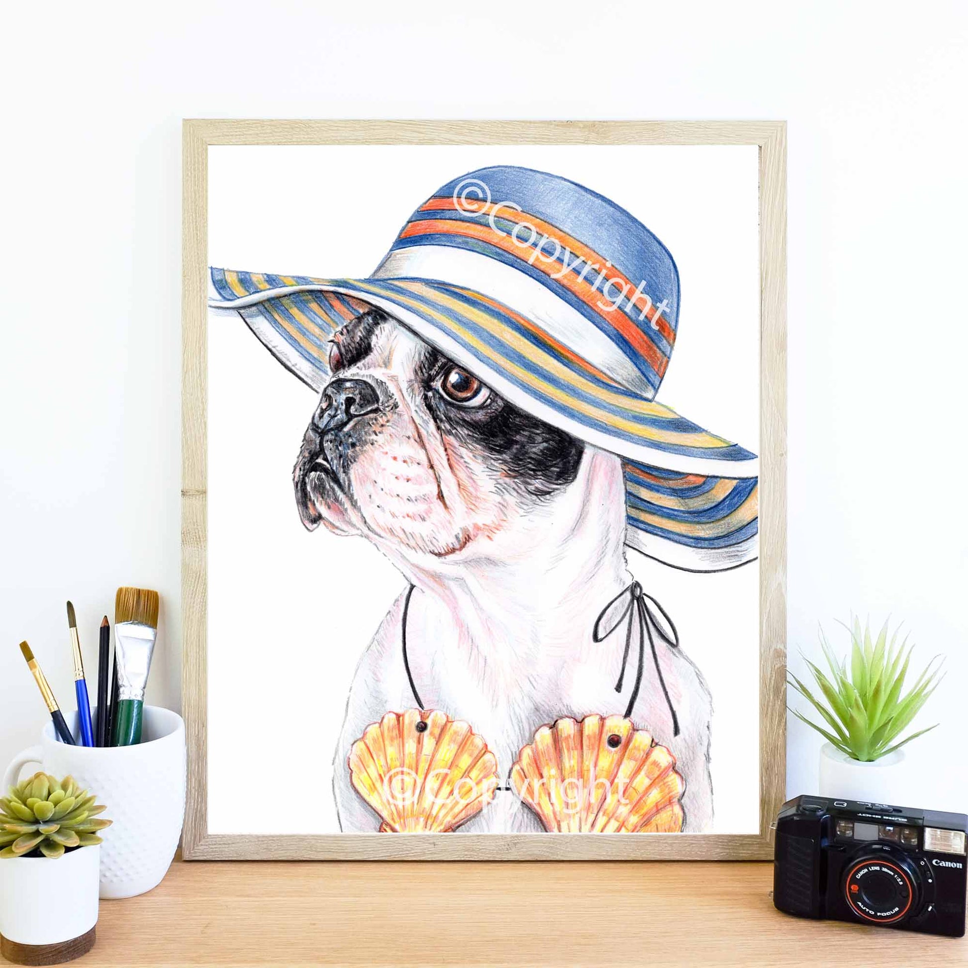 Crayon drawing of a boston terrier dog wearing a sun hat and a sea shell bikini. Art by Deidre Wicks